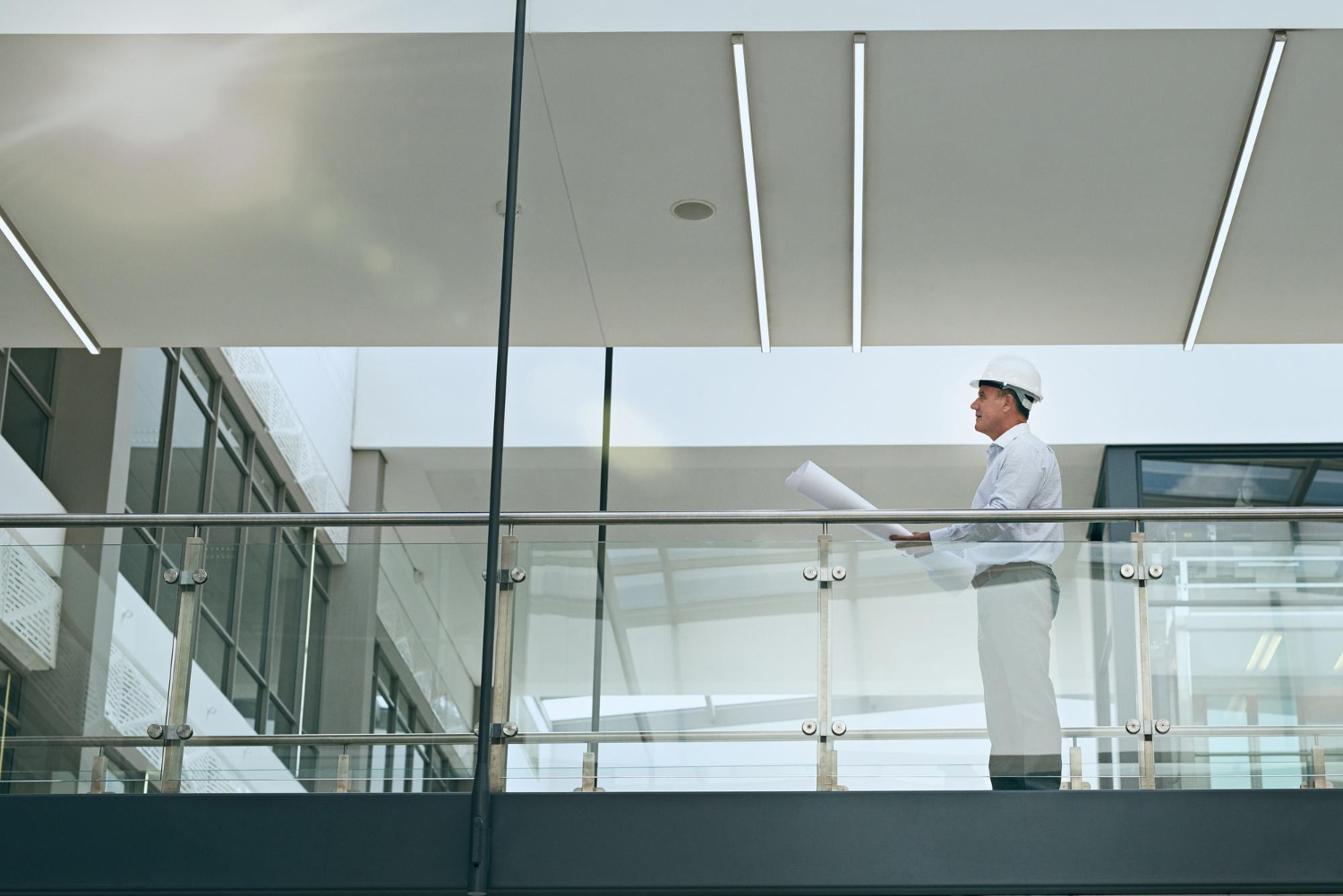 Worker looking at the newly installed glass window in commercial building – Glass Pro Dallas